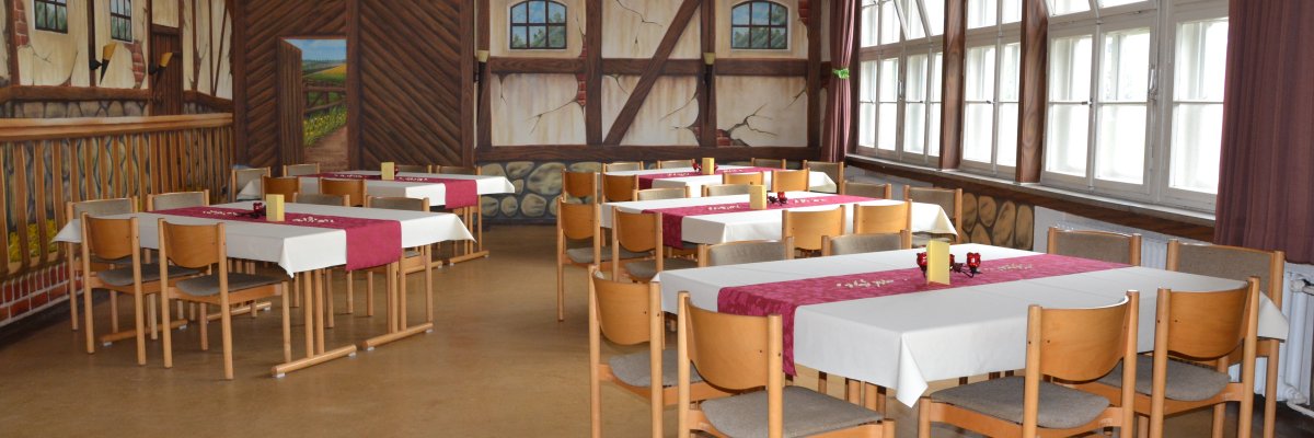 Dorfgemeinschaftsraum Raum mit Tischen und Stühlen